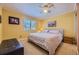 Bright bedroom with neutral walls, ceiling fan, plantation shutters and a padded bench at 4593 S Field St, Littleton, CO 80123