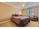 Relaxing bedroom with a cozy seating area, ceiling fan, and plantation shutters at 4593 S Field St, Littleton, CO 80123