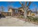 Cozy home featuring a wooden deck, brick accents, and a two-car attached garage at 4593 S Field St, Littleton, CO 80123