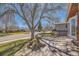 Inviting front yard featuring a wood deck, well-manicured lawn, and a mature tree, creating an appealing curb appeal at 4593 S Field St, Littleton, CO 80123