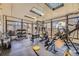 Bright home gym with natural light and large windows, featuring a variety of workout equipment and rubber flooring at 4593 S Field St, Littleton, CO 80123