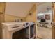 Modern laundry room boasts front-loading washer and dryer units, with an adjacent doorway to living area at 4593 S Field St, Littleton, CO 80123