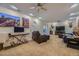 Cozy living room featuring plush leather seating, artwork, and a ceiling fan at 4593 S Field St, Littleton, CO 80123