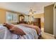 Comfortable main bedroom with ceiling fan, plantation shutters, and classic wood furniture at 4593 S Field St, Littleton, CO 80123