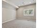 Basement bedroom with neutral colored walls, gray carpet, and window at 2485 Vale Way, Erie, CO 80516