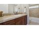 Bathroom with vanity, decorative mirror and tile backsplash at 2485 Vale Way, Erie, CO 80516