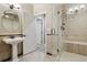 Bright bathroom featuring a pedestal sink and glass enclosed shower with built in bench at 2485 Vale Way, Erie, CO 80516