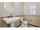 Powder room featuring a pedestal sink and a tile accent wall at 2485 Vale Way, Erie, CO 80516