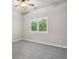 Bright bedroom featuring gray carpet and a window with verdant outdoor views at 2485 Vale Way, Erie, CO 80516