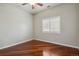 Bedroom featuring hardwood floors, a ceiling fan, and a window with shutters at 2485 Vale Way, Erie, CO 80516