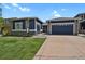Charming home featuring a two-car garage and a well-maintained lawn with stunning curb appeal at 2485 Vale Way, Erie, CO 80516