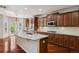 Spacious kitchen features a granite island, cherry cabinets, stainless appliances, and ample counter space at 2485 Vale Way, Erie, CO 80516