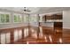 Spacious living room featuring hardwood floors and abundant natural light from large windows at 2485 Vale Way, Erie, CO 80516