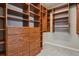 Walk-in closet with built-in shelves and drawers for ample storage space at 2485 Vale Way, Erie, CO 80516