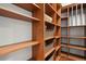 Large walk-in closet featuring custom shelving, providing ample storage space for an organized wardrobe at 2485 Vale Way, Erie, CO 80516