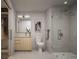 Modern bathroom featuring a glass-enclosed shower, wood vanity with marble countertop, and contemporary fixtures at 525 18Th St # 905, Denver, CO 80202