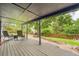 Relaxing covered back deck with a seating area and grill with a beautiful view of the landscaped yard at 1819 S Nile Ct, Aurora, CO 80012