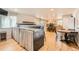 Entertainment area featuring a unique bar setup with seating, stylish curtains, and hardwood flooring at 1819 S Nile Ct, Aurora, CO 80012