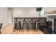 Stylish bar with stone accents, seating for four, and hardwood floors offers a modern and inviting space at 1819 S Nile Ct, Aurora, CO 80012