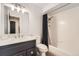 Bright bathroom with a shower-tub combo, a modern vanity, and clean white tiles at 1819 S Nile Ct, Aurora, CO 80012
