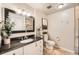 Well-lit bathroom with black countertop, modern fixtures, and neutral tile flooring at 1819 S Nile Ct, Aurora, CO 80012
