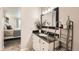 Bathroom vanity with a black countertop, stylish decor, and a view to a bedroom at 1819 S Nile Ct, Aurora, CO 80012