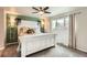 Cozy bedroom featuring a decorative headboard, stylish lighting fixtures, and a ceiling fan at 1819 S Nile Ct, Aurora, CO 80012