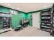 Custom bedroom with green walls, vanity, mirror, and ample closet space for storing shoes and clothes at 1819 S Nile Ct, Aurora, CO 80012