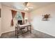 Bright bedroom with neutral walls, carpet floors, a ceiling fan, desk, and a window with tree views at 1819 S Nile Ct, Aurora, CO 80012