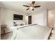 Comfortable bedroom featuring a ceiling fan, TV, neutral decor and closet space at 1819 S Nile Ct, Aurora, CO 80012
