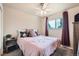 Bedroom with a ceiling fan, a window with natural light, and a comfortable bed at 1819 S Nile Ct, Aurora, CO 80012