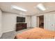 Finished basement bedroom with a TV, ample closet space, and neutral carpeting at 1819 S Nile Ct, Aurora, CO 80012