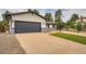 Exterior showing a two-car garage with painted garage door and a well manicured lawn and yard at 1819 S Nile Ct, Aurora, CO 80012