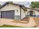 Exterior view showcasing the front of the house and front yard with stucco and brick accent architecture at 1819 S Nile Ct, Aurora, CO 80012