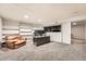 Spacious office with built-in shelving, a brown leather chair, neutral carpet, and large monitors at 1819 S Nile Ct, Aurora, CO 80012