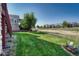 Well-manicured lawn in a beautiful backyard with view of neighborhood homes at 8107 S Catawba Ct, Aurora, CO 80016