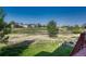 A level backyard backs to open space, with mature trees and a sprinkler system at 8107 S Catawba Ct, Aurora, CO 80016