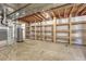 Unfinished basement has wooden support beams, built-in shelves and visible mechanics at 8107 S Catawba Ct, Aurora, CO 80016