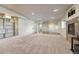 Spacious basement with carpet, a fireplace, and built-in shelving at 8107 S Catawba Ct, Aurora, CO 80016