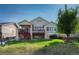 Exterior showcasing the deck with stone pillars, the backyard, and the overall property at 8107 S Catawba Ct, Aurora, CO 80016