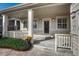 Inviting front porch with decorative columns, charming door, and fresh landscaping at 8107 S Catawba Ct, Aurora, CO 80016