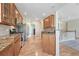 This kitchen features stainless steel appliances, custom cabinetry, and seamlessly connects with the living area at 8107 S Catawba Ct, Aurora, CO 80016