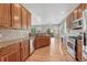 Bright kitchen featuring stainless steel appliances, granite countertops, and hardwood flooring at 8107 S Catawba Ct, Aurora, CO 80016