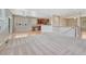 Open-concept living room featuring hardwood floors, bright windows, and a seamless transition to the kitchen area at 8107 S Catawba Ct, Aurora, CO 80016