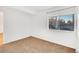 Well-lit bedroom with neutral walls, carpet flooring, and a window at 13651 E Yale Ave # C, Aurora, CO 80014