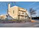 Side view of tan multi-unit building with stone retaining wall at 13651 E Yale Ave # C, Aurora, CO 80014