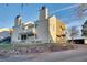 Rear view of tan multi-unit building with stone retaining wall at 13651 E Yale Ave # C, Aurora, CO 80014