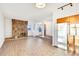 Bright living room with wood-look floors, stone fireplace and kitchen at 13651 E Yale Ave # C, Aurora, CO 80014