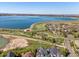 Expansive aerial view showcasing a home nestled near a scenic lake and walking trails at 6266 W Prentice Ave, Littleton, CO 80123