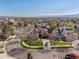 A neighborhood view featuring a home with a well-manicured lawn and a three-car garage at 6266 W Prentice Ave, Littleton, CO 80123